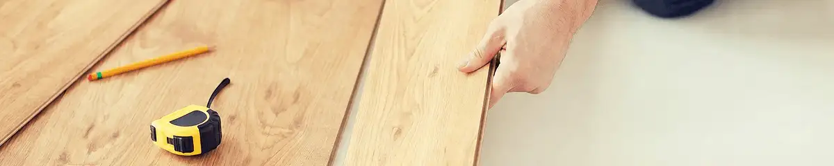 A professional installing wood flooring in Madison, WI