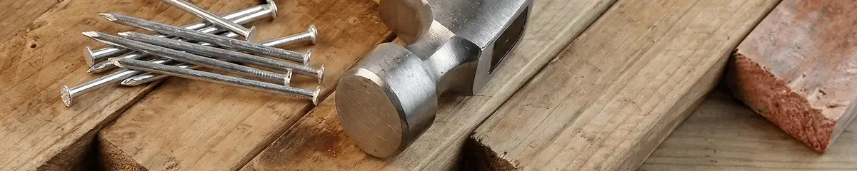 Hammer and nails on hardwood flooring boards in Madison, WI