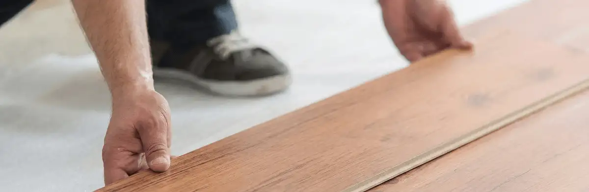 A professional installing laminate flooring in Madison, WI
