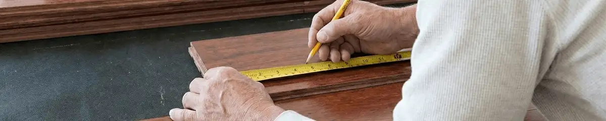 A professional installing wood flooring in Madison, WI